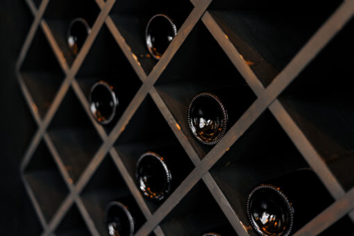 elite dark glass wine bottles stacked on wooden ra 2023 06 27 22 28 16 utc